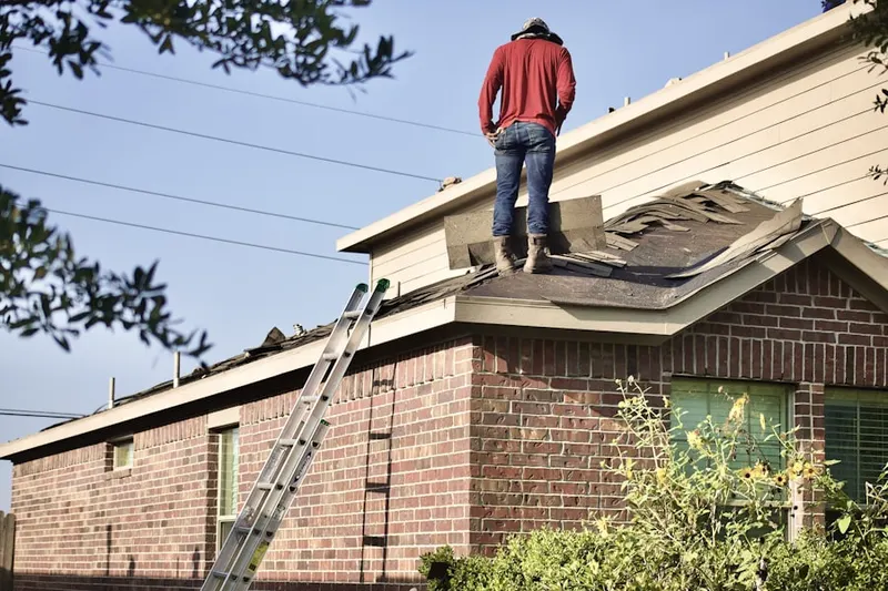 Professional roofer working on a residential roof in Leon Valley